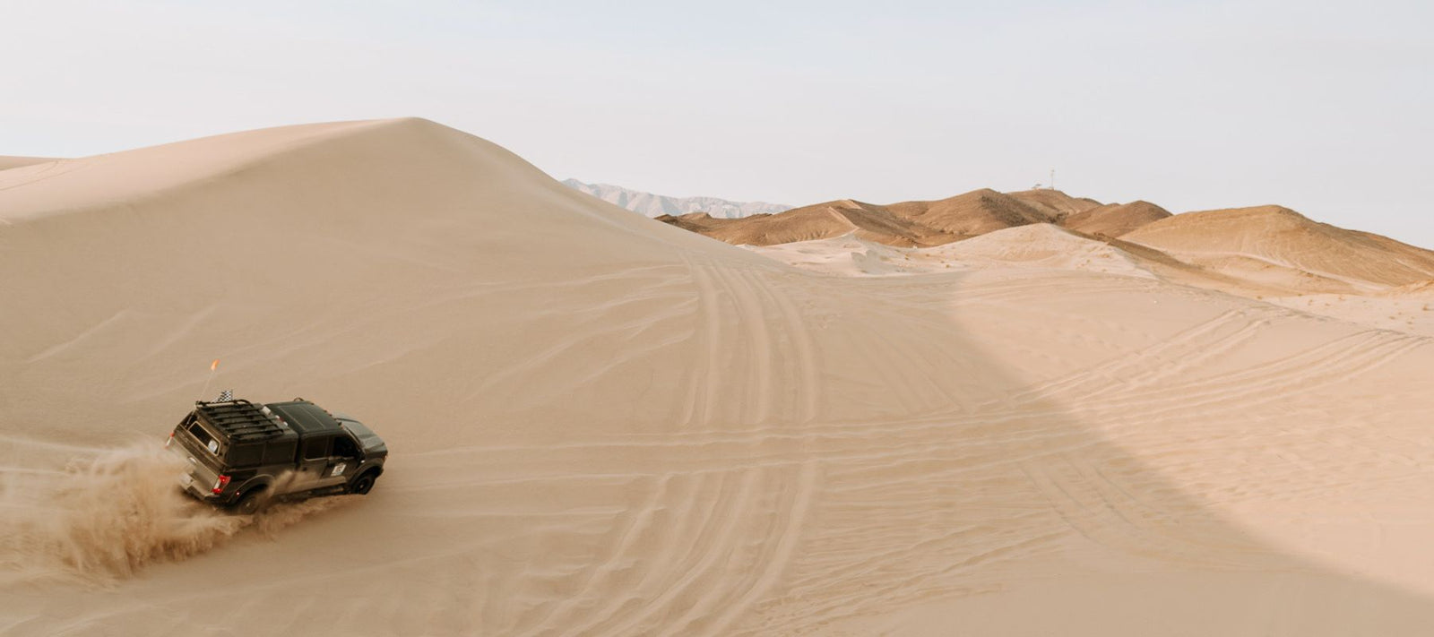 Ford Roush F250 driving over sand dunes